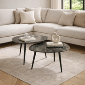 Modern living room with a beige sectional sofa and two marble coffee tables.